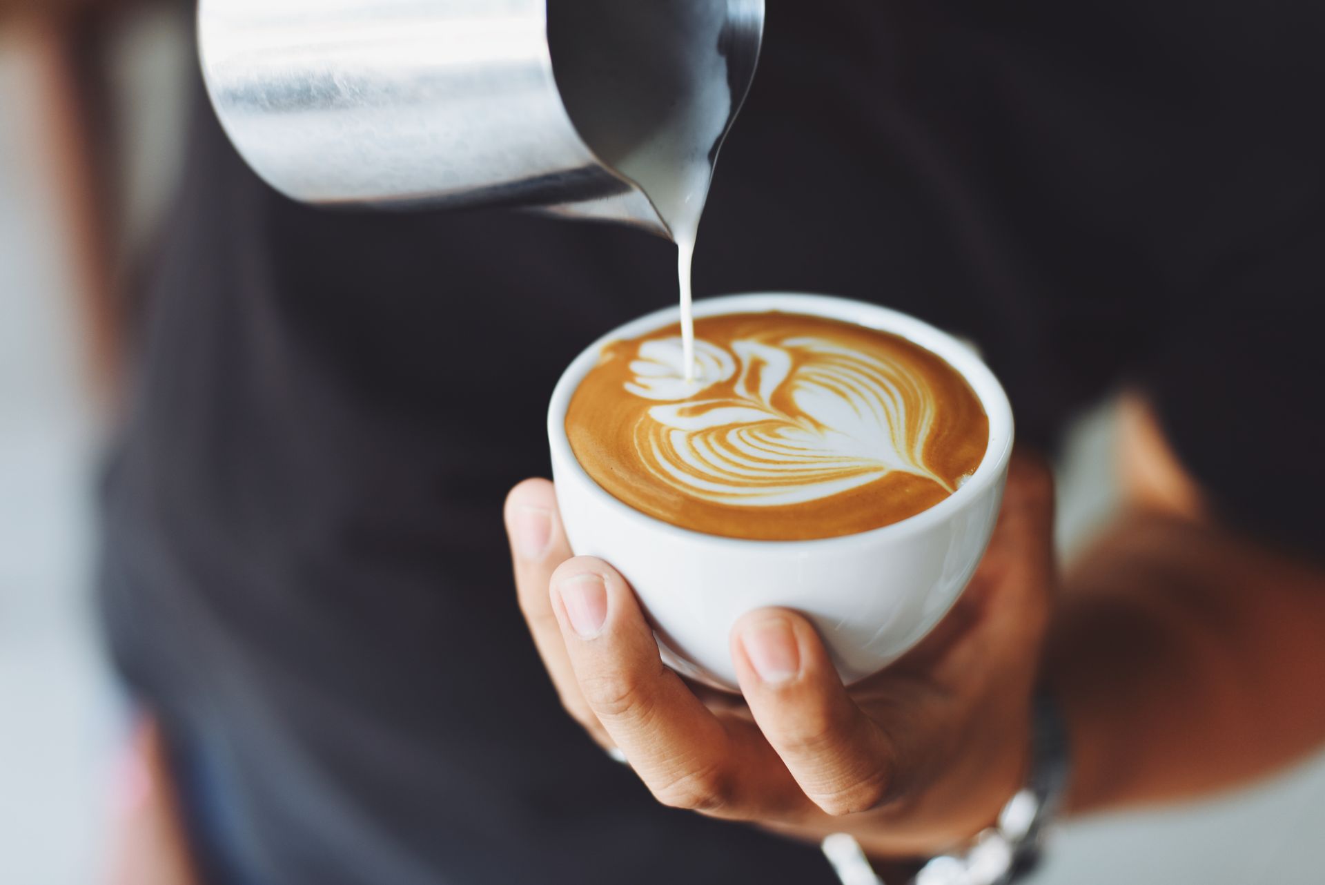 Freshly poured latte art in a ceramic cup